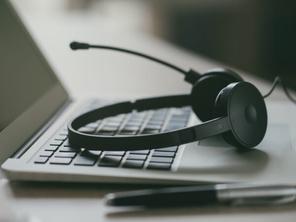 Close up headset of call center on office table, operation job concept Close up headset of call center on office table, operation job concept